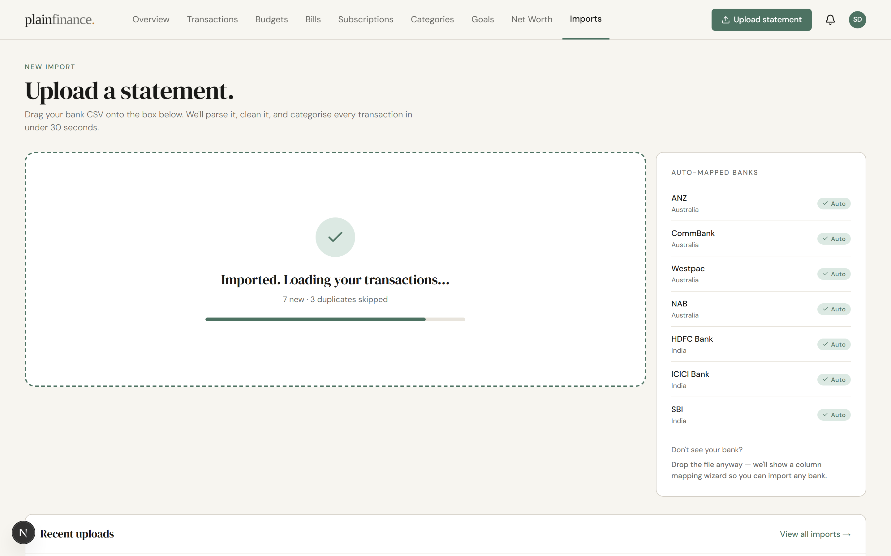 Post-import done screen reading "Imported. Loading your transactions..." with "7 new · 3 duplicates skipped" below it